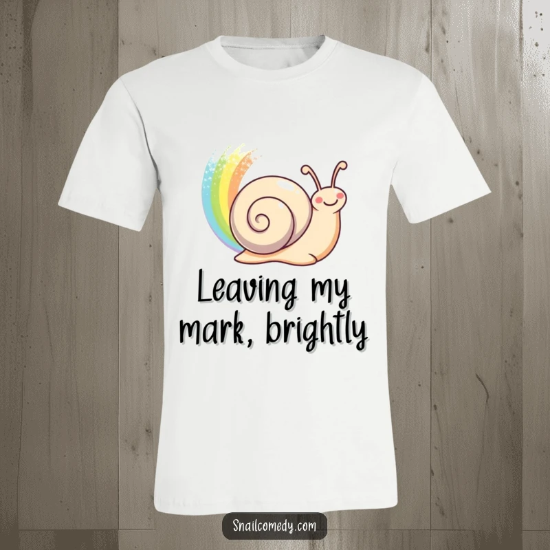 Funny happy snail leaving a shimmering rainbow trail behind on a soft t-shirt, a dazzling funny gift.