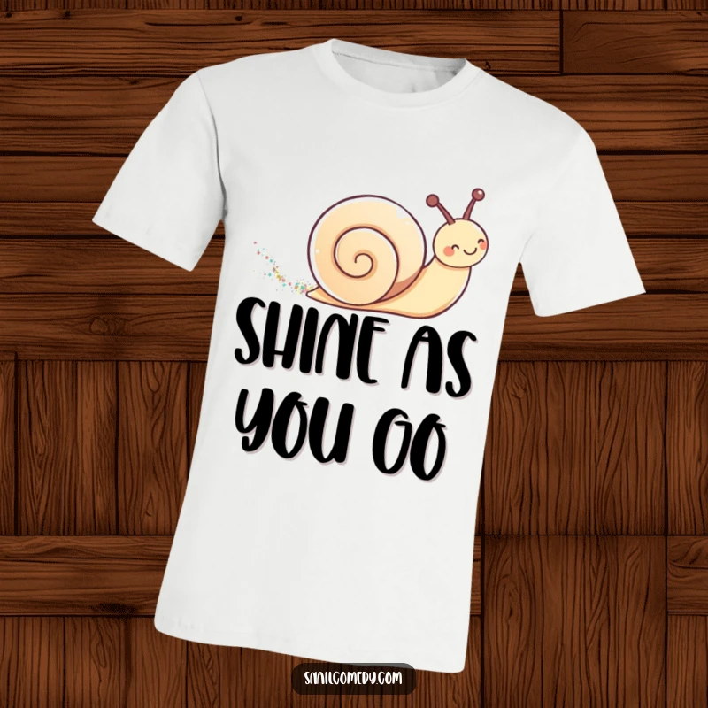 Cute kawaii snail leaving a shimmering glitter trail on a t-shirt, embodying playful magic.